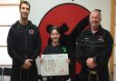 Lucy Ranales-Griffiths with her black belt certificate
