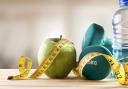 A generic photo of a dumbells, an apple, tape measure and water. Picture: PA Photo/thinkstockphotos.