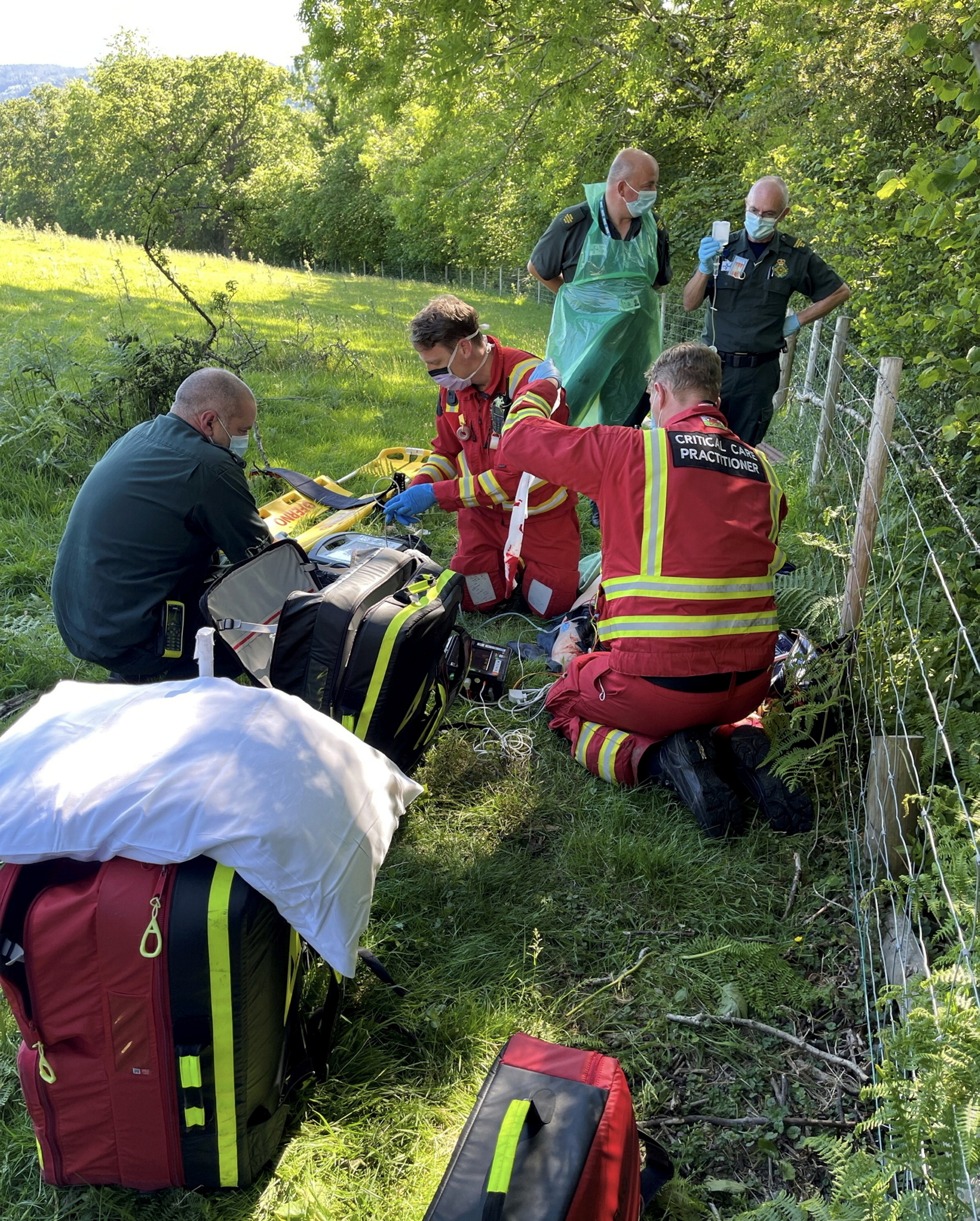 Norman Roberts, 64 being helped by emergency teams following the crash. 