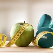 A generic photo of a dumbells, an apple, tape measure and water. Picture: PA Photo/thinkstockphotos.