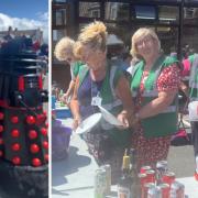 Janet Finch-Saunders with a Dalek and (right) volunteers at St David's Hospice Summer Fair.