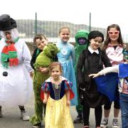 Pupils (pictured from the snowman) Hari, Albie, Rhiannon, Daynie, Henry, Lyla, Walter and Jasmine. The children dressed up in fancy dress last week in exchange for an item for the Christmas hampers.