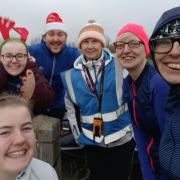 Conwy run director Bethan Wyn Roberts (centre) with identical twins Amanda and Karen Durber and some other festive parkrunners.