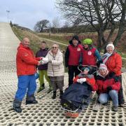 Rhos-on-Sea Rotary President Pauline Hogan presents the cheque to members of the local Para Snow Sports Wales group.