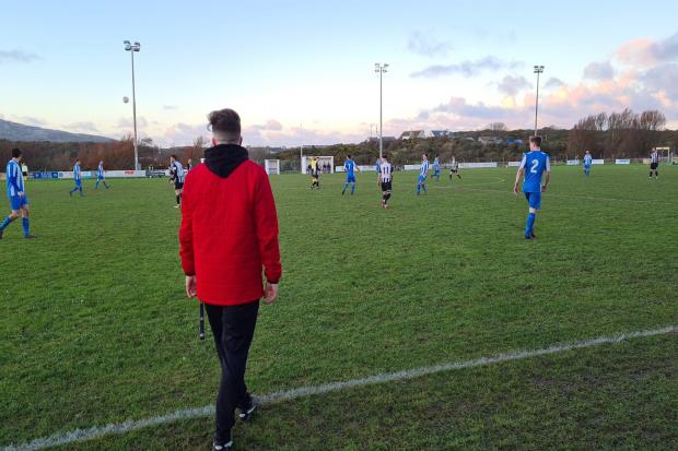 Llandudno manager Sean Eardley watches over the game