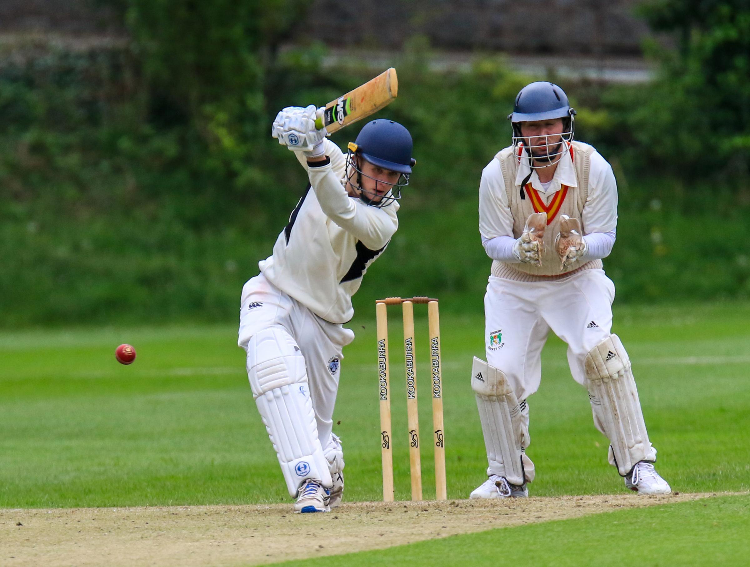 Penrhos Ryda School batsman smashes the red ball back at the bowler. Picture: Tony