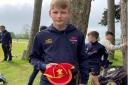 Casey Bedford with his Wales cap after being selected to represent his country at under-13s level.