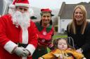 Santa and his helper with Matilda and her mum Michelle.