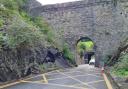 Pedestrians are walking through Conwy Castle's arch, rather than using a safer underpass..