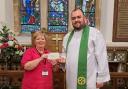 Reverend Samuel Erlandson pictured with the representative from Ty Gobaith at St Hilary's Church
