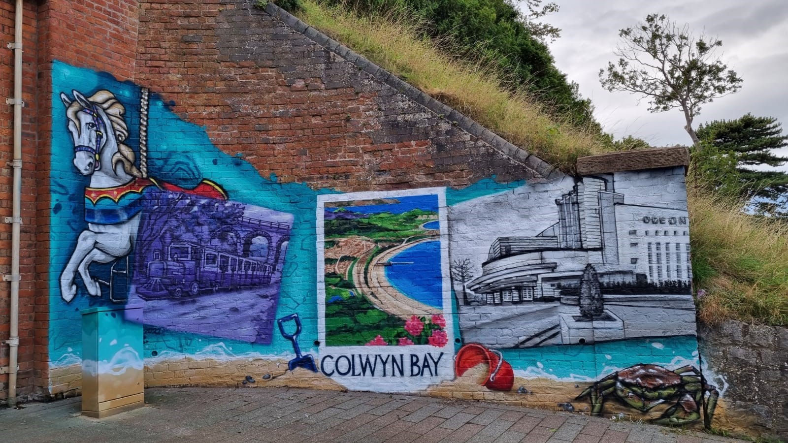 The mural celebrates the history of Colwyn Bay, including old attractions and seaside scenes.