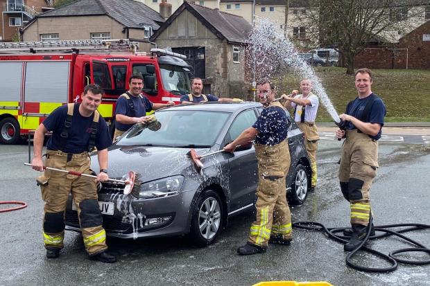 Firefighters wash cars in Llangollen. (Image: North Wales Fire & Rescue Service)