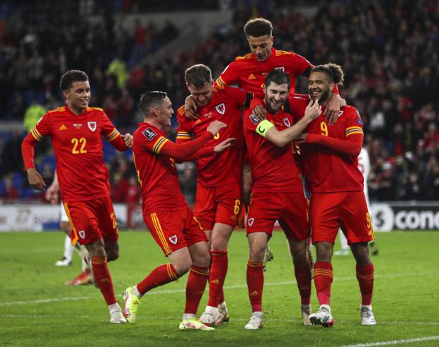 North Wales Pioneer: Wales' Ben Davies (second right) celebrates scoring their side's fourth goal of the game during the FIFA World Cup Qualifying match at the Cardiff City Stadium, Cardiff. Picture date: Saturday November 13, 2021.