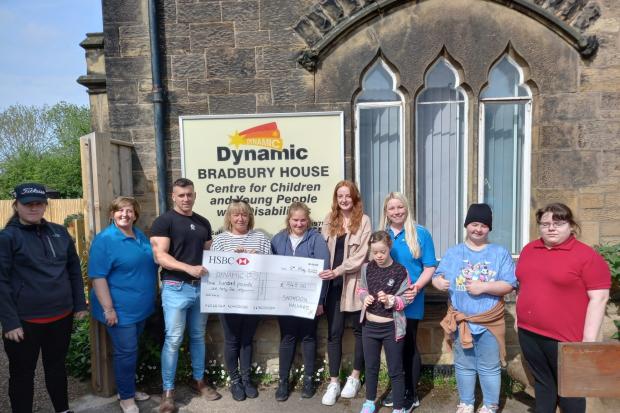 Members of the Snowdon Challenge team hand over a cheque to Dynamic.