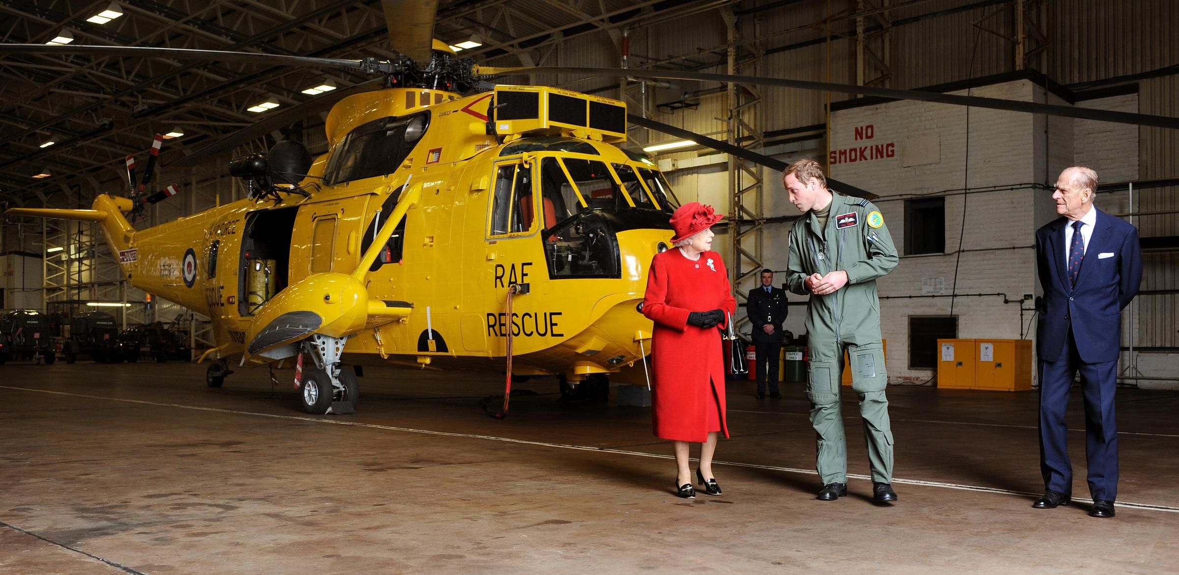 File photo dated 1/4/2011 of Prince William showing Queen Elizabeth II and the Duke of Edinburgh the Sea King Helicopter he flies during his training as a Search and Rescue pilot during a visit to RAF Valley in Anglesey. 