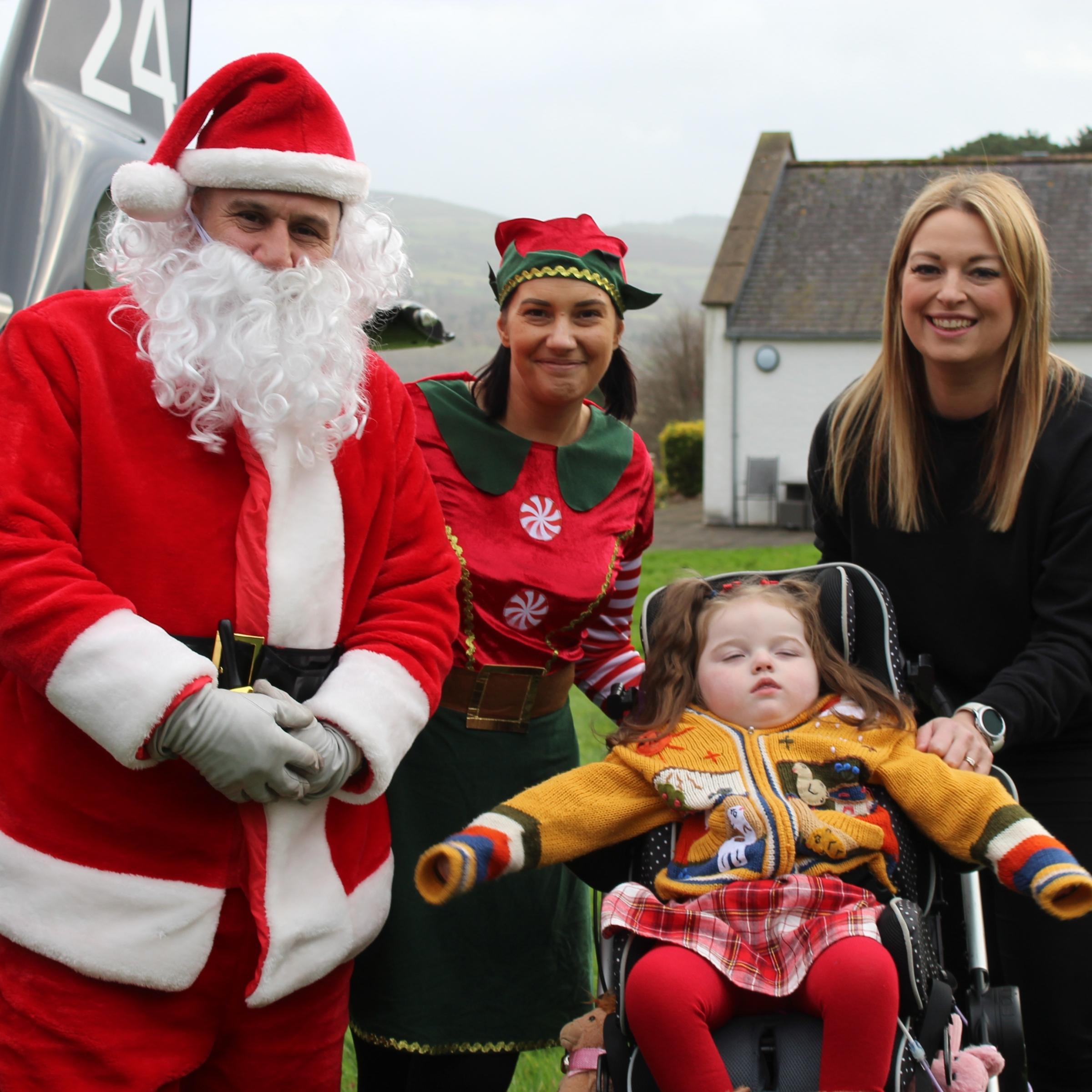 Santa and his helper with Matilda and her mum Michelle.