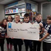 Colwyn Bay Rugby Club minis and the cheque they received from the Co-op