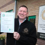 South Caernarfon Creameries Compliance Secretary Elwyn Jones with the Level 3 Green Dragon award for the manufacture, on-site storage and packing of cheese.