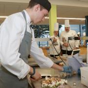 A young chef competing under the watchful eyes of judges at a previous Welsh International Culinary Championships.