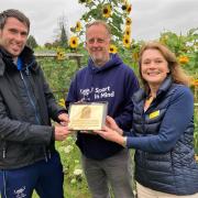 Berkshire County Organiser Heather Skinner presents the National Garden Scheme plaque to Neil Harris ( CEO of its parent charity 'Sport In Mind') and Tony Young, who also works for the NHS and runs the project itself. Photo: National Garden Scheme