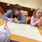 Sunday School leader Karen Erlandson with Anwen and other children thinking about 'How we can build a strong foundation on Jesus.'