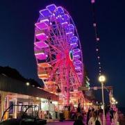 Llandudno Pier's giant Ferris Wheel is back 'home'. Pictured: The wheel lit up at night.