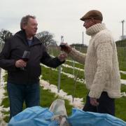 Colin Bennett, owner of the vineyard, and Gareth Wyn Jones, a farmer whose family have worked the land near the vineyard for 375 years. Photo: BBC