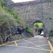 Pedestrians are walking through Conwy Castle's arch, rather than using a safer underpass..