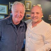 Les Dennis with customer Jim Molloy.