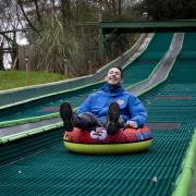 'It’s a tough job but somebody’s got to do it!' Rides and activities manager Peter Froment road tests the slide